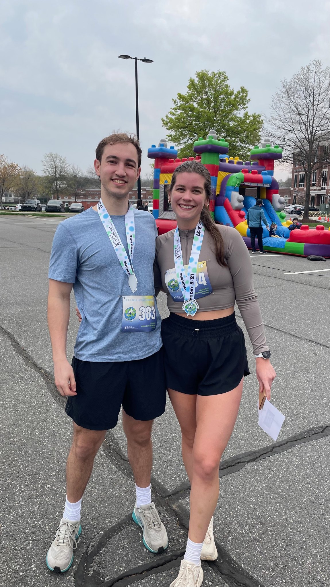 Brooke and Sean wearing race medals, arms around each other on race day