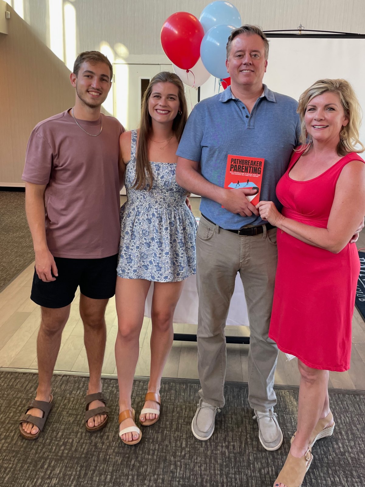 Seth Marlowe holding Pathbreaker Parenting at its launch, with Sean, Brooke, and Donna